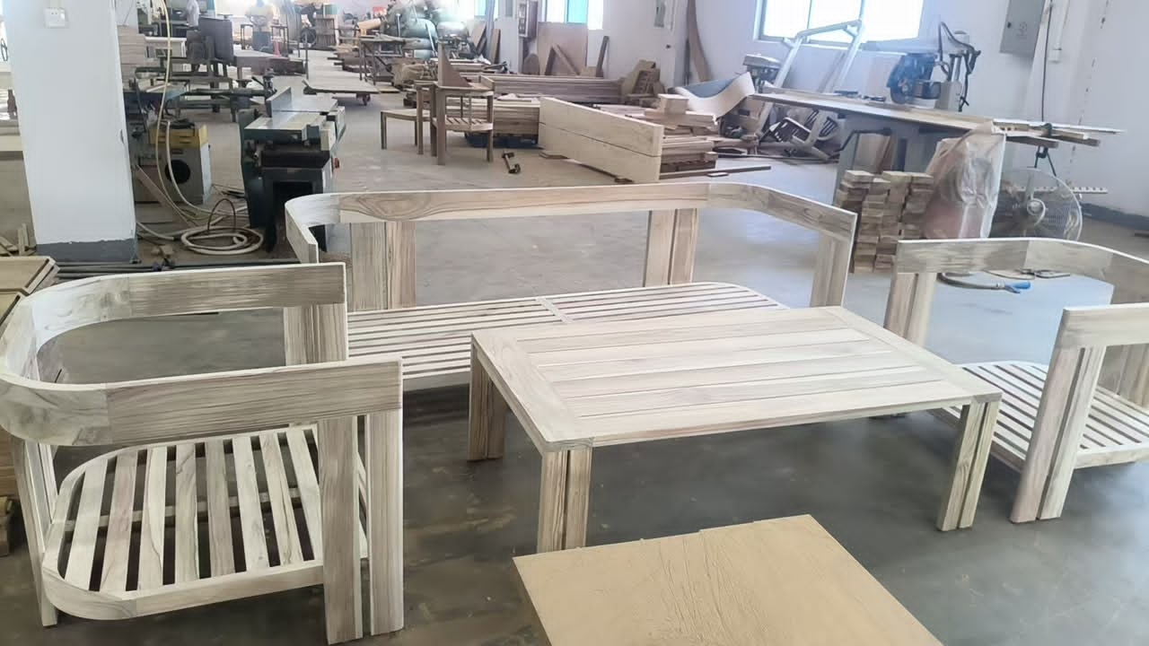 Custom teak wood outdoor furniture set being crafted in workshop